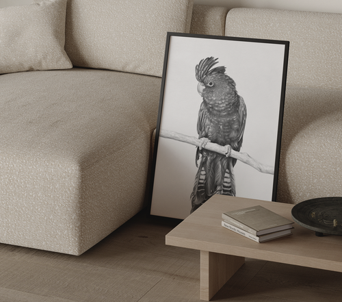 Framed artwork of a parrot on a wall next to a beige sofa.